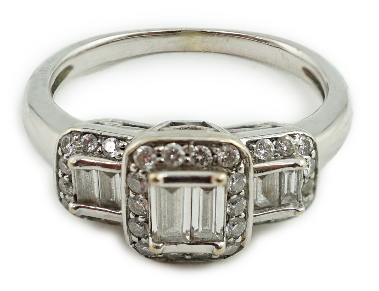 A modern white gold and diamond stepped triple cluster dress ring